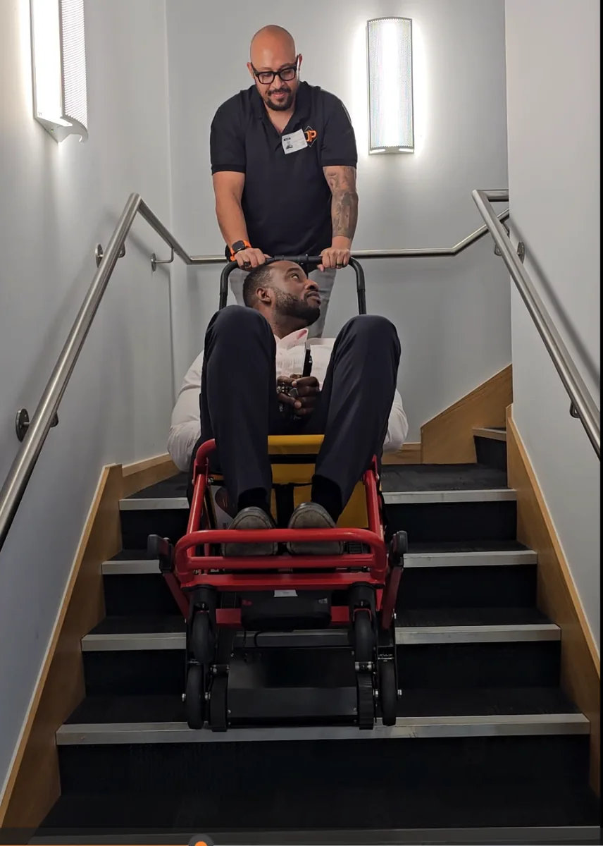 An evacuation chair being operated down a stairwell