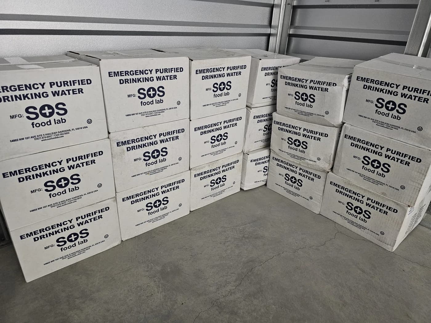 Pallets of emergency drinking water in the Outpost store room