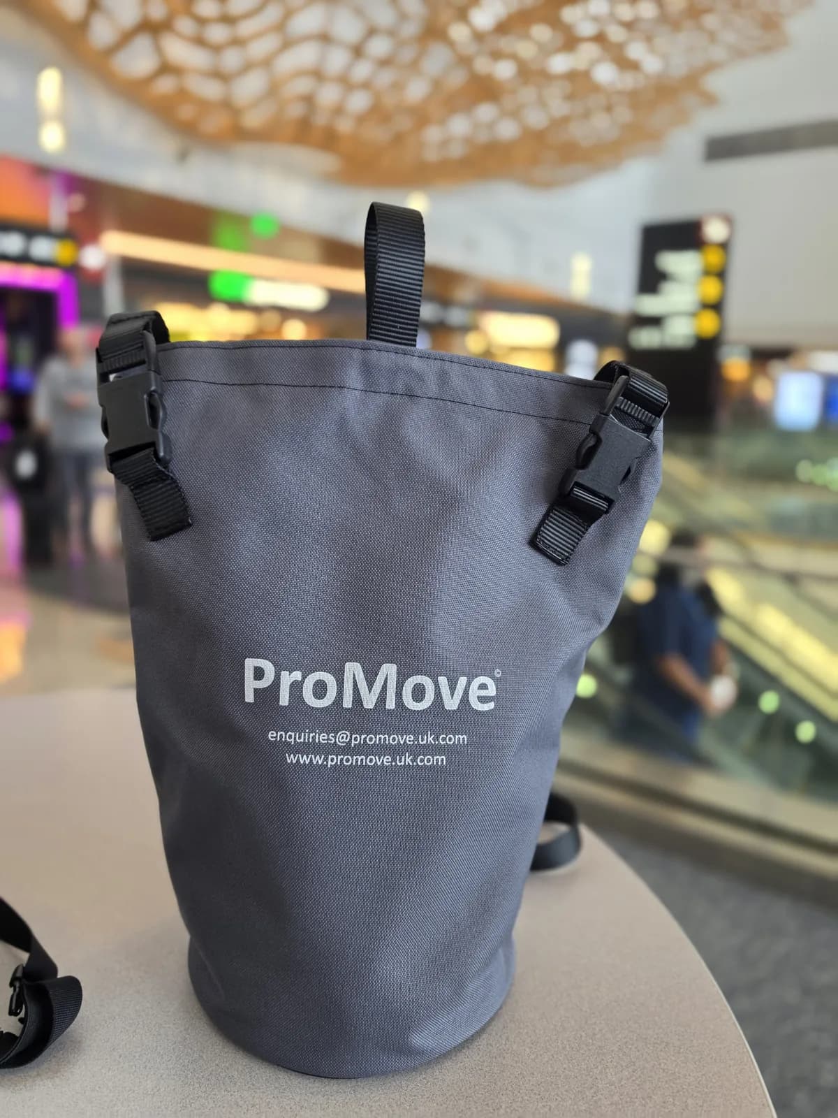 A ProMove transfer sling in its carry bag at an airport terminal