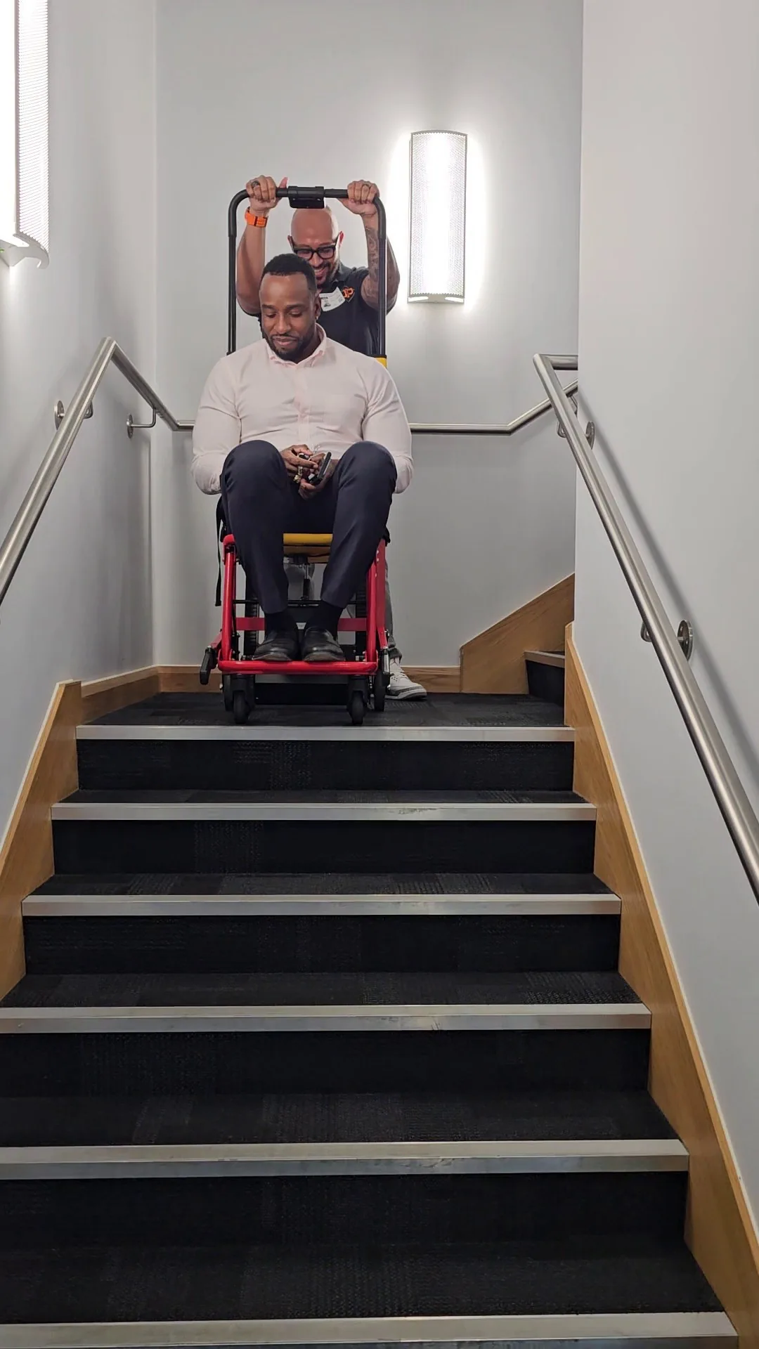 A resident being brought down a staircase in a HALO evacuation chair