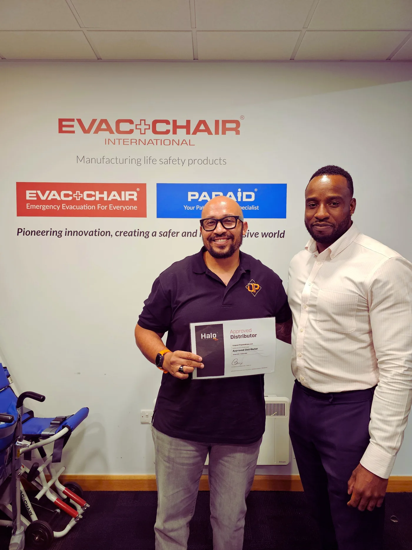 Drew Jennings receiving the Outpost distributor certificate at Evac+Chair International