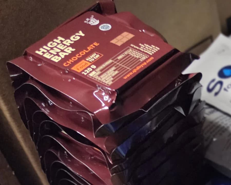 Emergency food bars counted out on the bench before packing