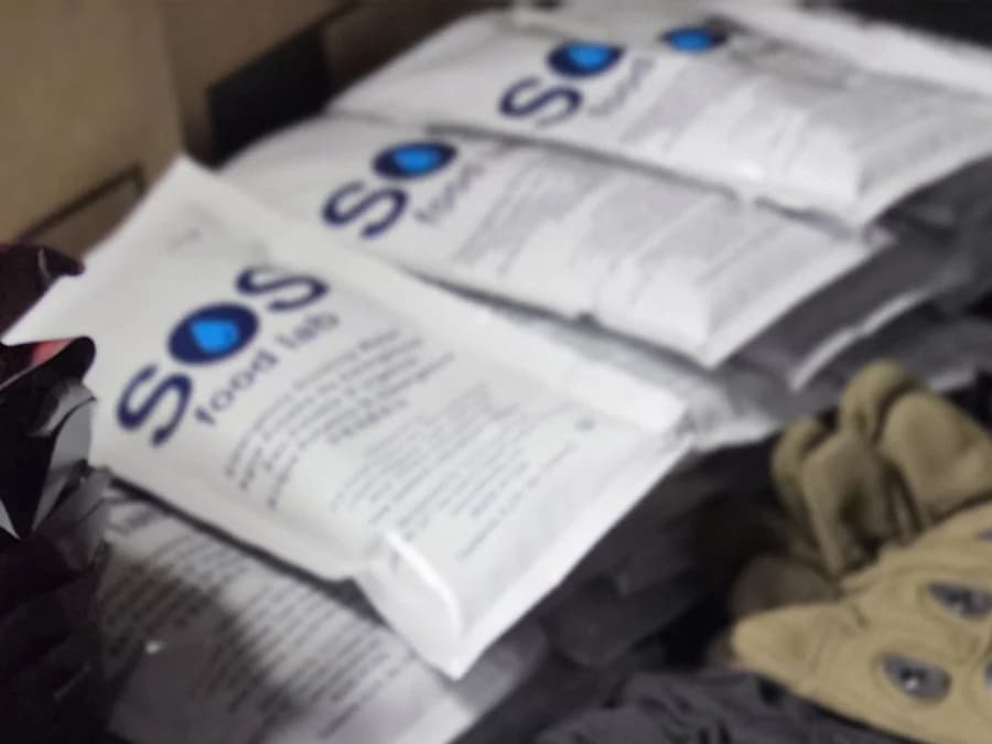 Sealed emergency drinking water pouches counted out before packing