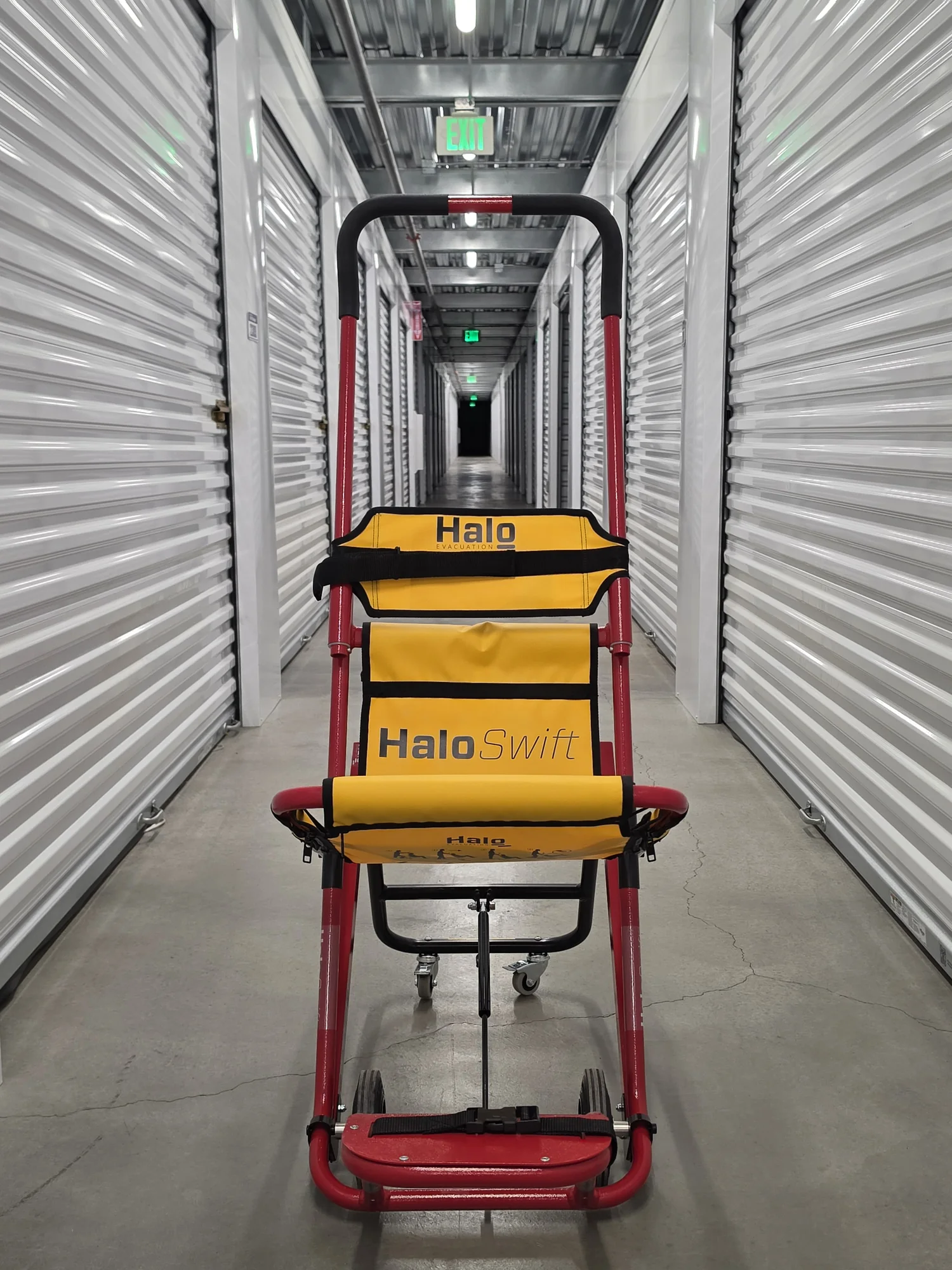 A HALO Swift evacuation chair standing in a building corridor, seen head-on