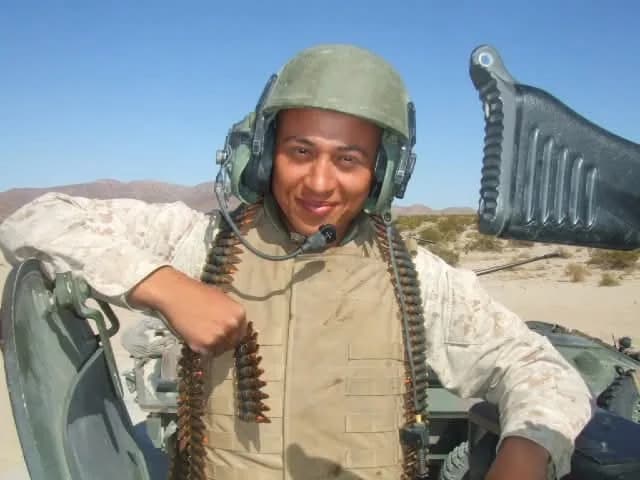Corporal Jennings in a vehicle turret with an ammunition belt, Twentynine Palms