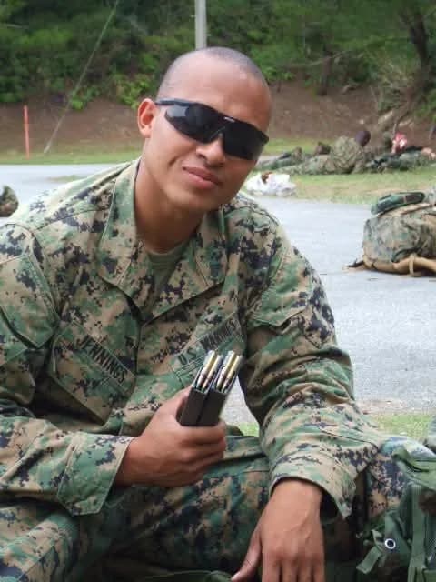 Sergeant Jennings kneeling in utilities during a field exercise